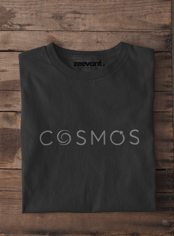 Black t-shirt with 'COSMOS' and 'zeevant' text on a wooden surface