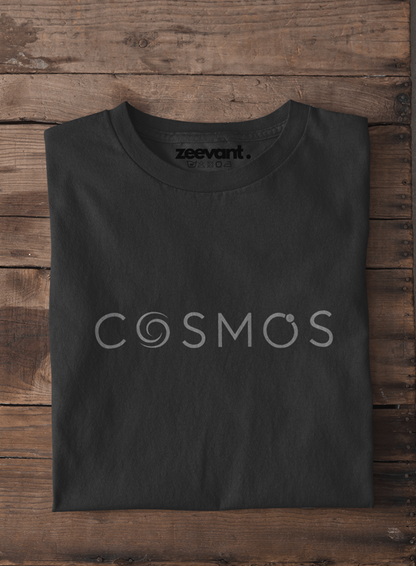 Black t-shirt with 'COSMOS' and 'zeevant' text on a wooden surface