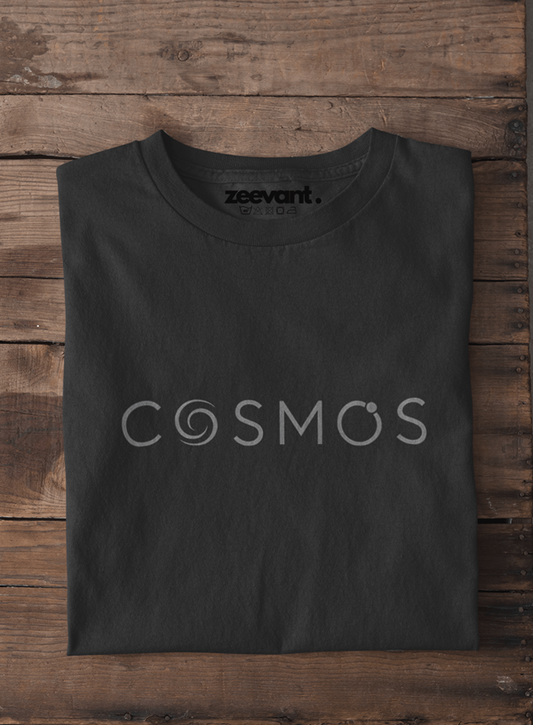 Black t-shirt with 'COSMOS' and 'zeevant' text on a wooden surface