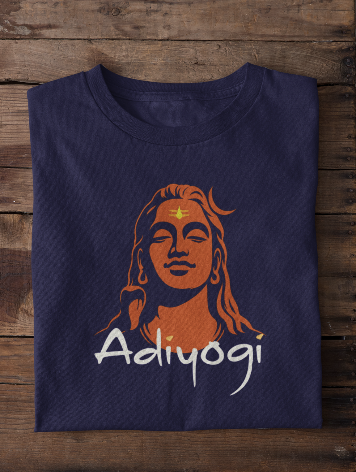 Navy blue t-shirt with orange and white graphic design on a wooden surface